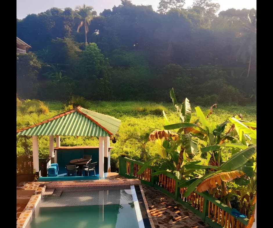 Elevated view of private swimming pool and cabana overlooking green hills