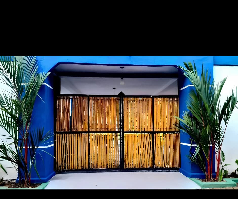 Secure private entrance with blue pillars and bamboo gates at Anu Villa